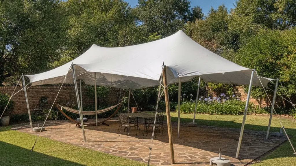 Waterproof white stretch tent tensioned over a paved garden patio in a Pretoria suburb